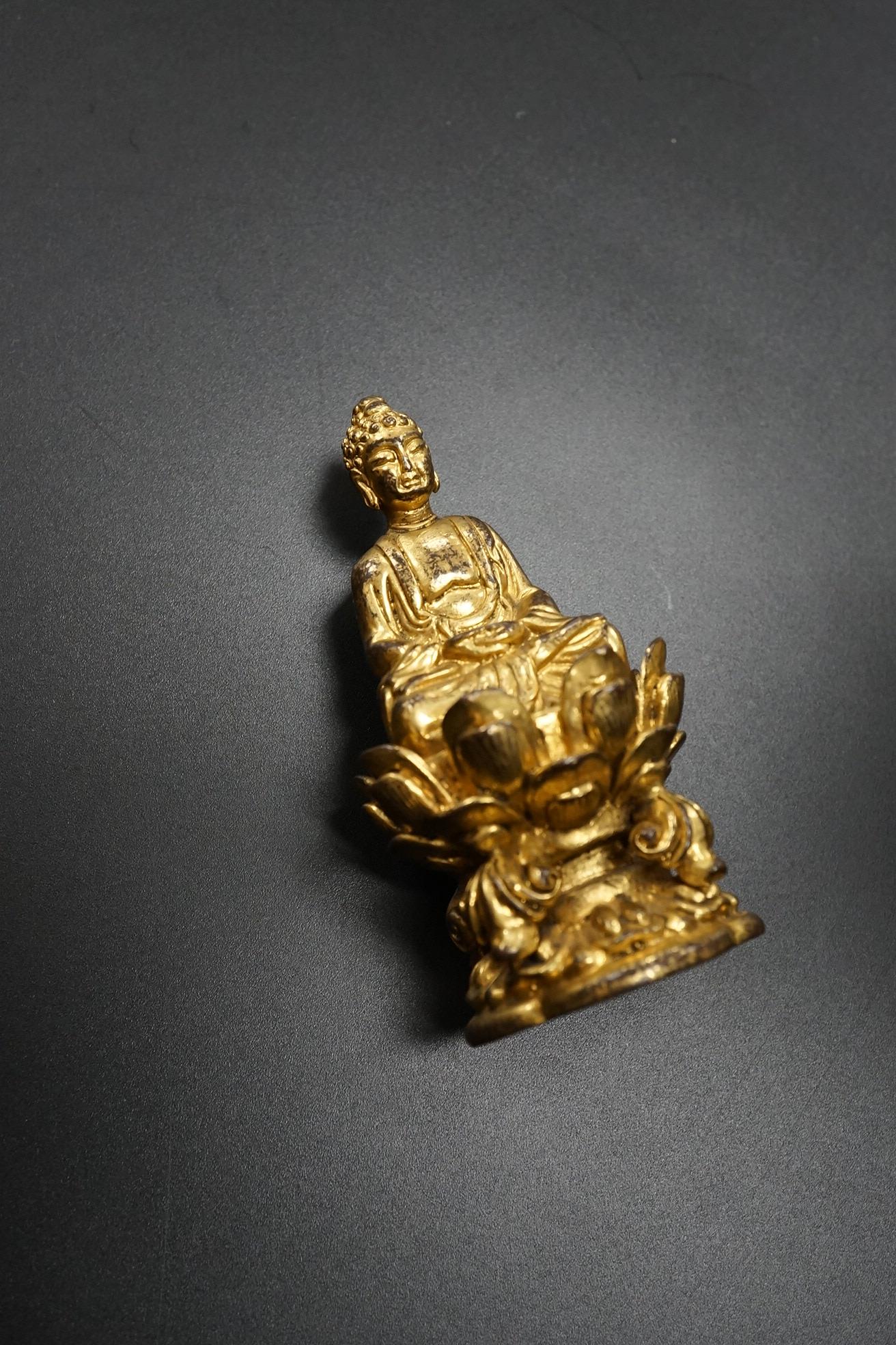 A Chinese miniature gilt metal figure of seated Buddha, 8cm high
